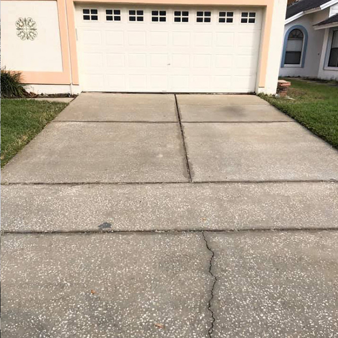 dirty private driveway after pressure washing